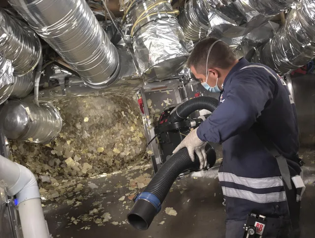 Rehoboth Air Duct Cleaning specialist operating negative pressure cleaning equipment for thorough duct maintenance in Rehoboth