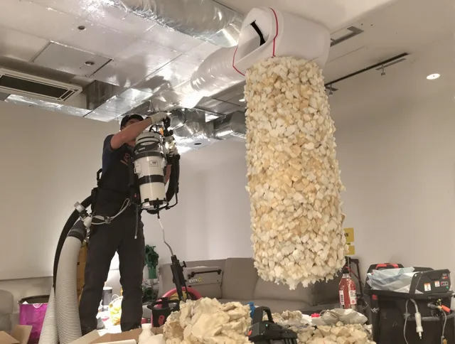 Rehoboth Air Duct Cleaning technician performing precision vacuum insulation removal in a residential property in Rehoboth